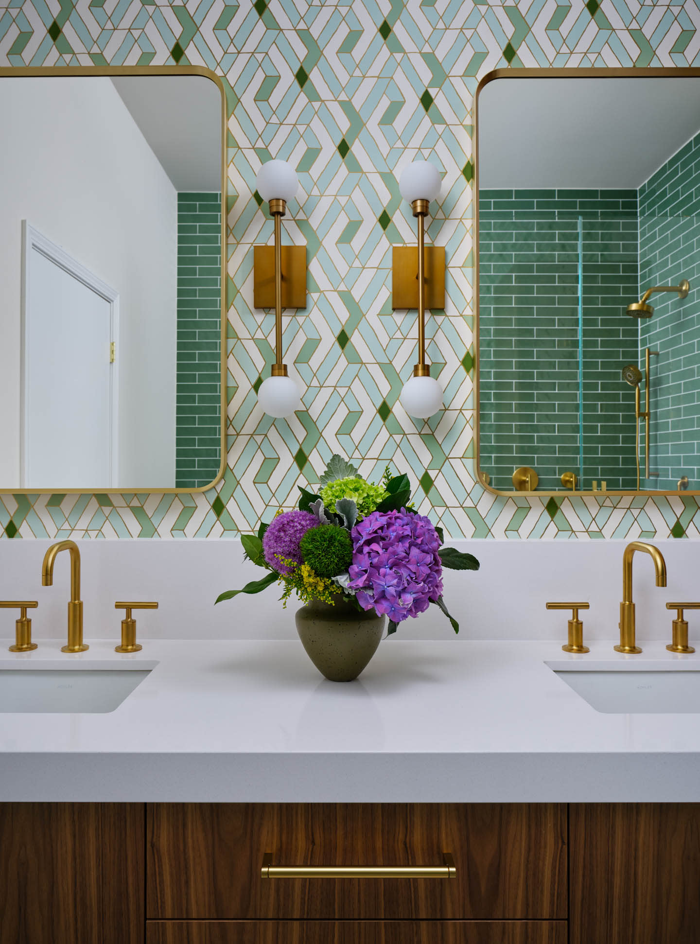 green tile bathroom with a dark wood vanity and gold finishes