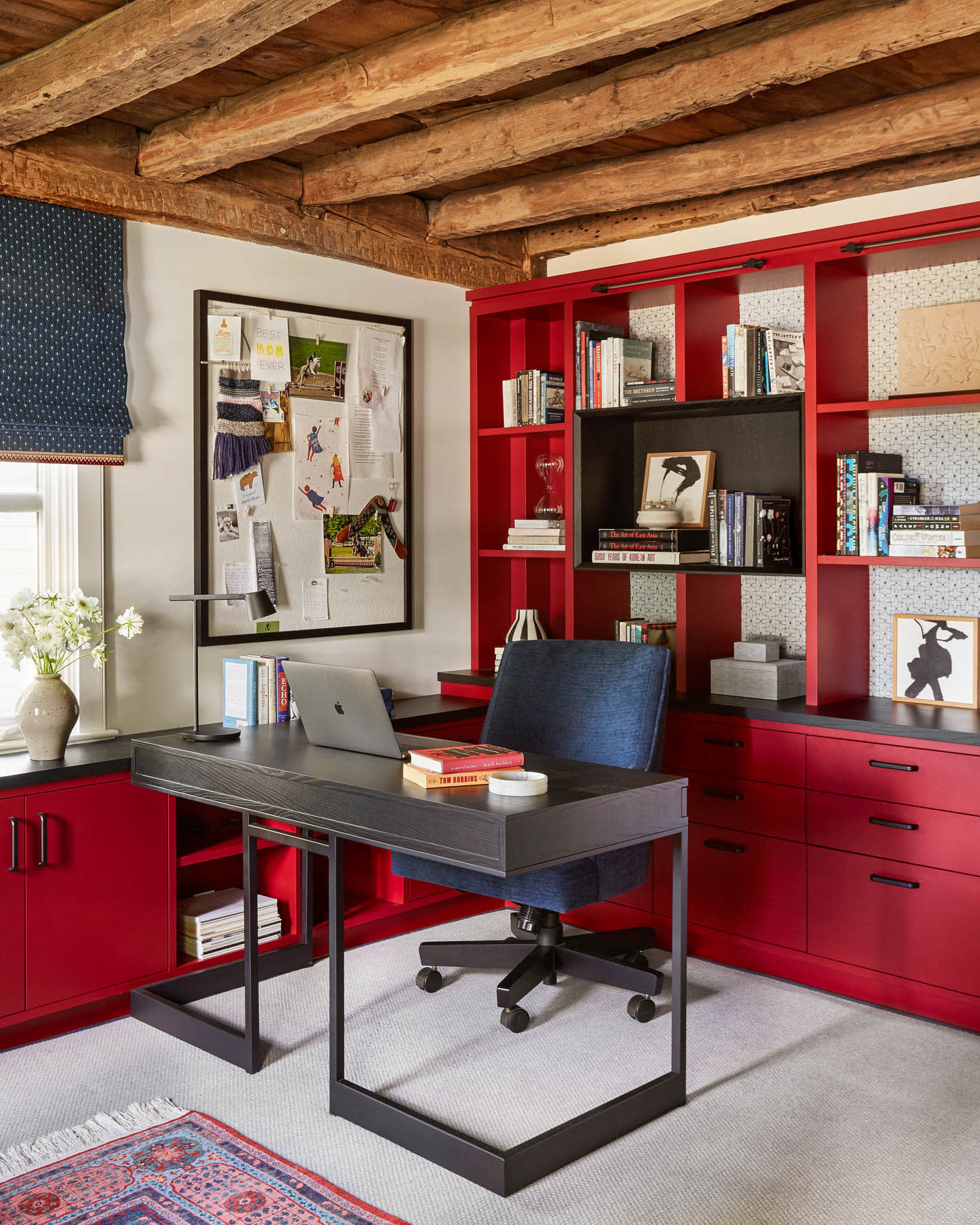 bright red millwork in an office with exposed wooden beam ceiling