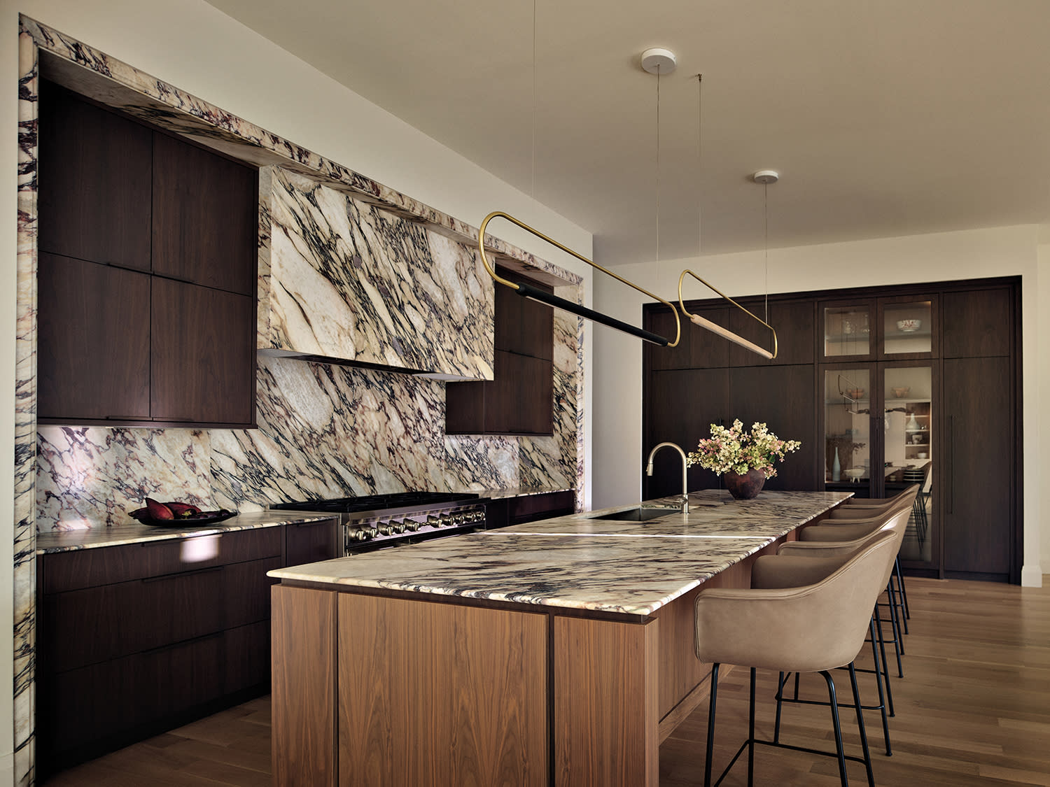 modern kitchen with bold marble and walnut cabinetry