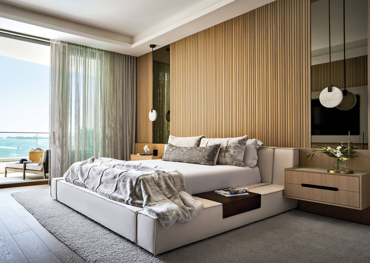 contemporary bedroom with a wood wall headboard and inset mirrors on each side