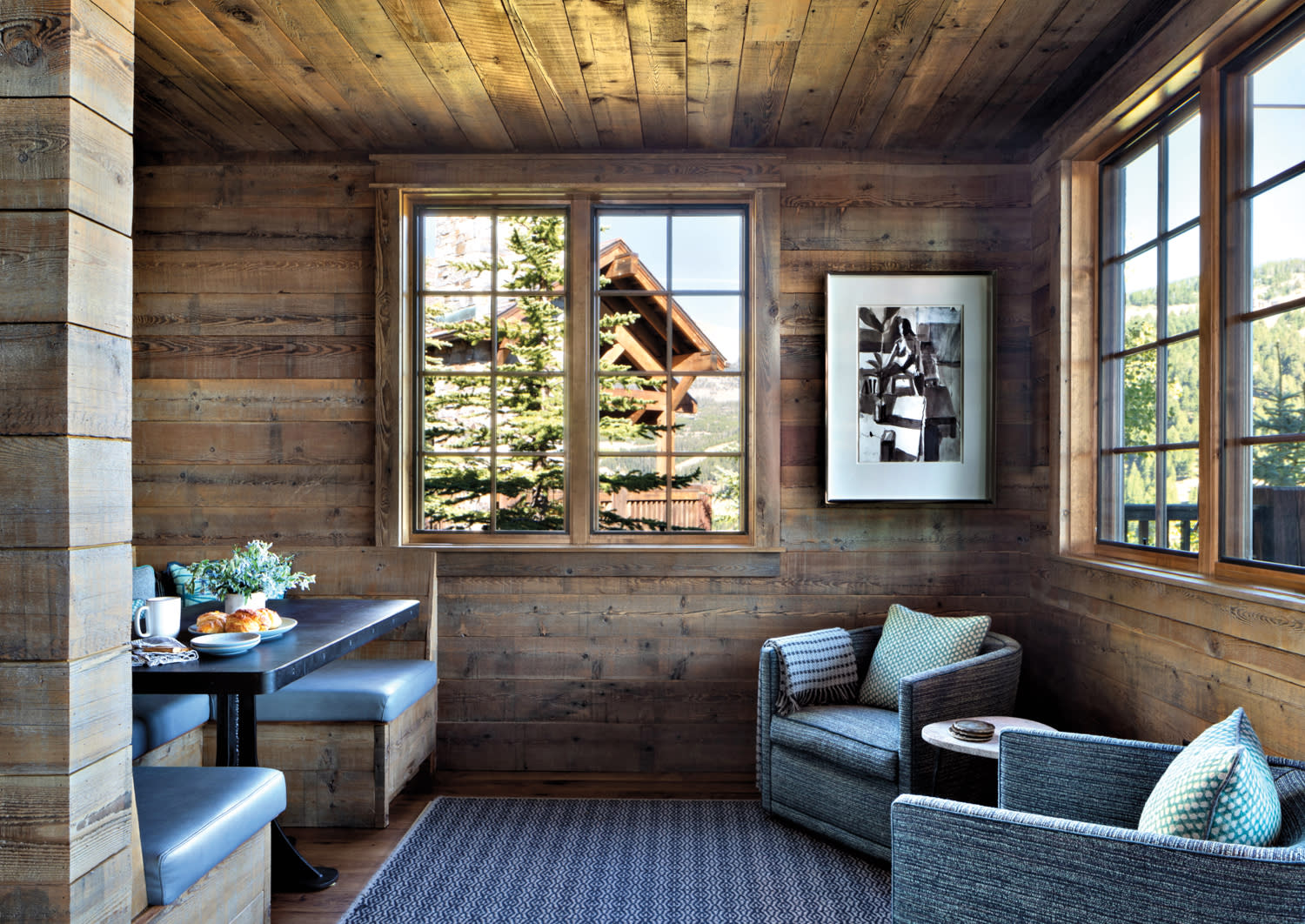 A breakfast nook is paneled in reclaimed wood